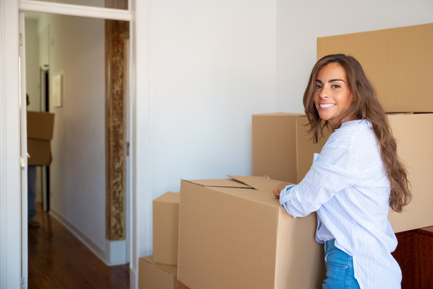 cheerful-beautiful-young-hispanic-woman-unpacking-stuff-her-new-apartment-standing-near-stacks-carton-boxes_74855-8852