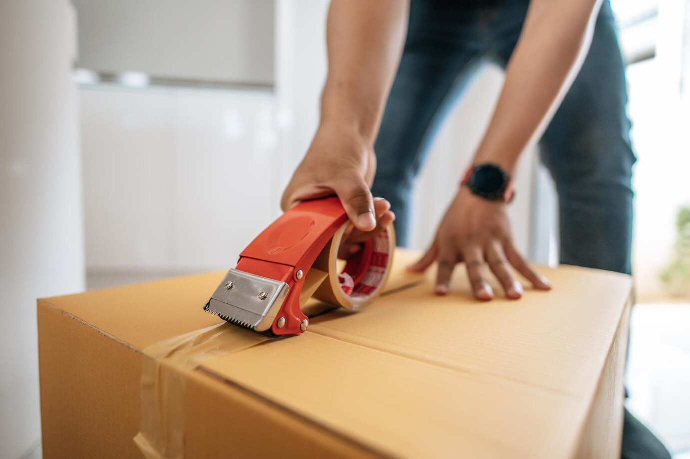 close-up-hand-man-use-glue-tape-close-cardboard-box-sealing-big-box-packing-moving-new-house-concept-selective-focusx9cardboard-box_1150-58847